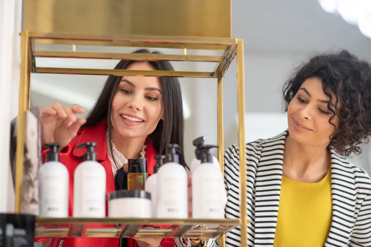Two ladies shopping for hair products.